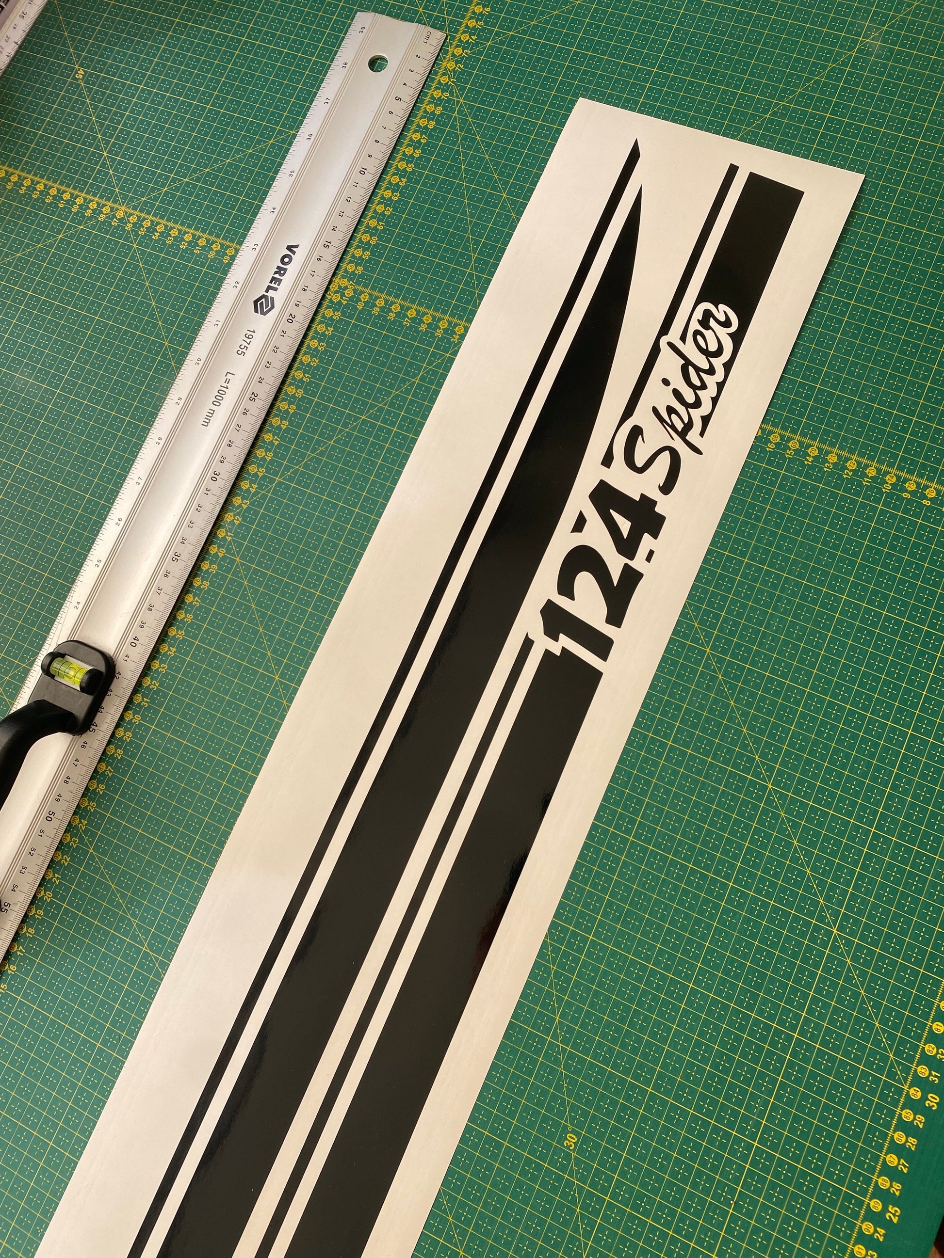 A black and white striped vinyl decal with the text '124' and 'Lakes' displayed on a measuring board.