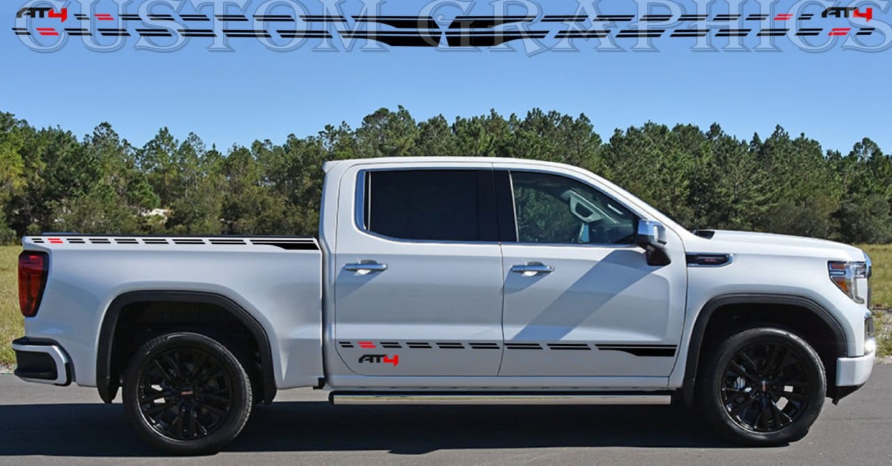 A white GMC Sierra truck with a premium vinyl sticker featuring a rocket design on the side.