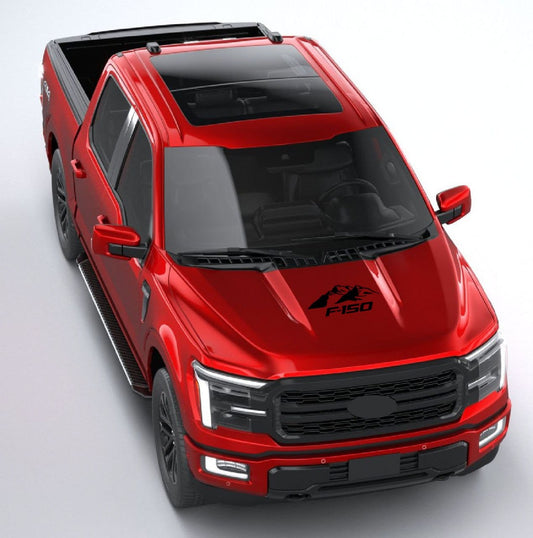 A red Ford F-150 truck with a black vinyl sticker on its hood featuring mountain graphics.