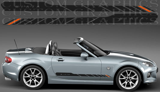 A silver Miata convertible car shown in side profile on a dark gray studio background, with a large repeated 'CUSTOM GRAPHICS' watermark across the top and black side decals with orange accents applied to the vehicle.