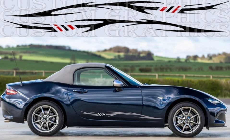 A dark blue convertible sports car shown in side profile against a blurred countryside background, with a large black, white, and red decal graphic displayed across the top of the image.