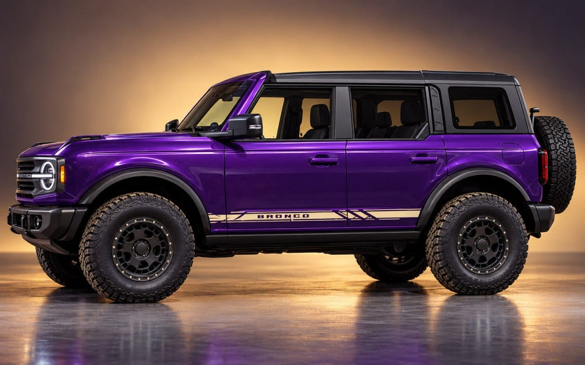 A purple Ford Bronco SUV with black wheels, black trim, and a spare tire mounted on the rear side, photographed in a studio setting with a warm gradient background.