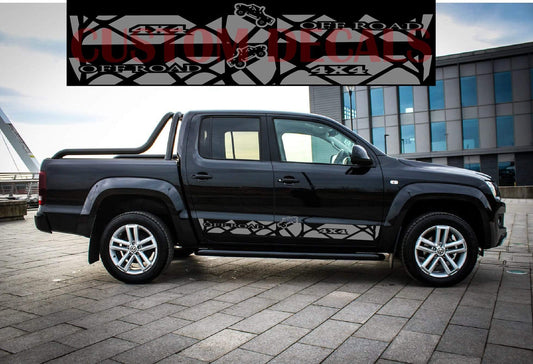 A black VW Amarok truck with line stickers applied to its body, showcasing a sleek, customized appearance.