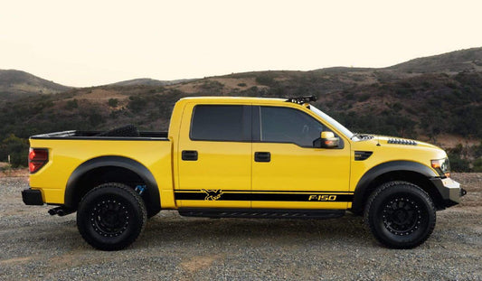 A yellow Ford F-150 pickup truck with a set of black racing stickers applied on the side.